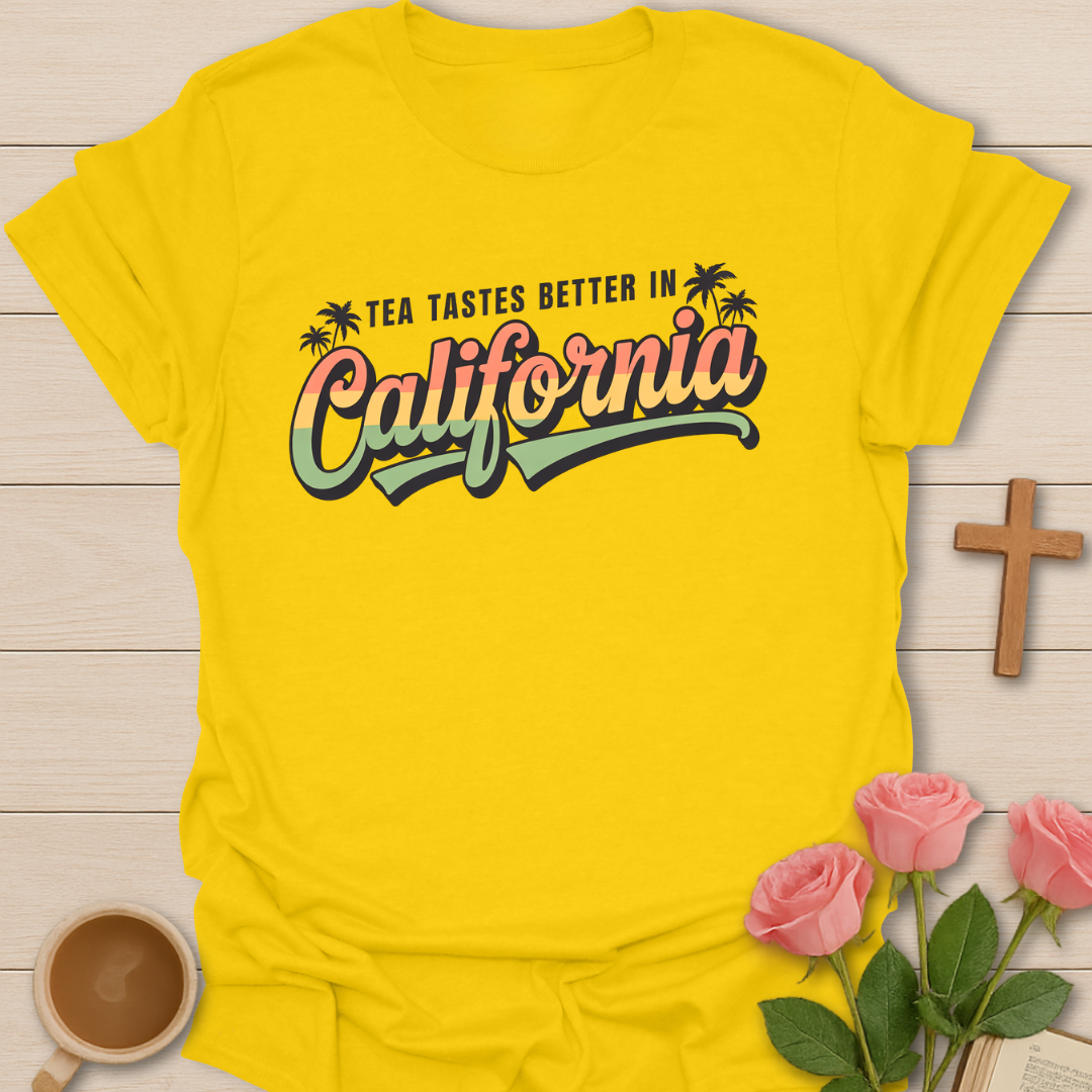 Yellow Women’s tea lover t-shirt with retro sunset lettering reading “Tea Tastes Better in California,” cozy California aesthetic graphic tee.