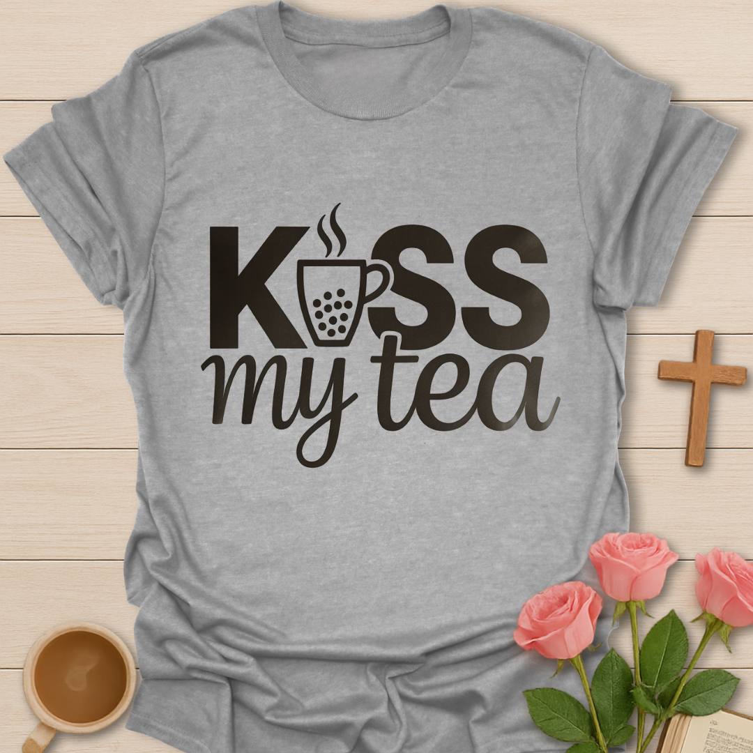 Gray Kiss My Tea graphic t-shirt design with bold lettering and a steaming tea cup icon on a dark background