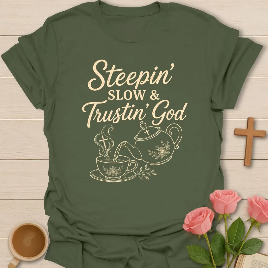 Steepin Slow and Trustin God shirt with teapot pouring tea, teacup, cross steam, floral line art, and cream lettering. - Military Green