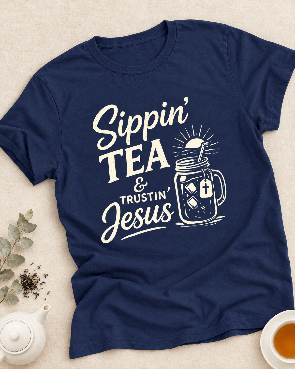 African American woman in a cream Jesus Tea And Me T-shirt holding a teacup beside an open Bible in a cozy living room, with Faith + Tea Classics collection text above.