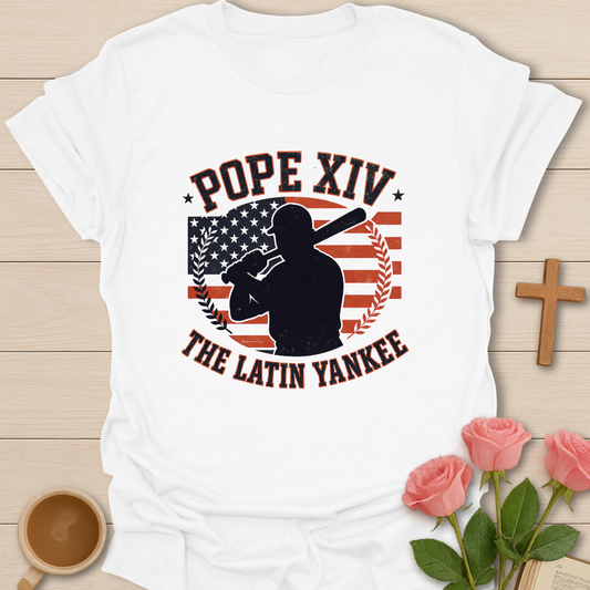 White Christian baseball graphic shirt featuring Pope XIV “The Latin Yankee” silhouette with American flag, faith symbolism, and patriotic design.