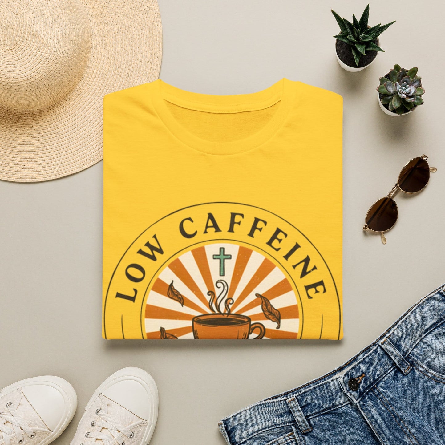 Low Caffeine High Faith shirt with Hojicha tea cup, sunburst, cross, falling leaves, and circular badge design.