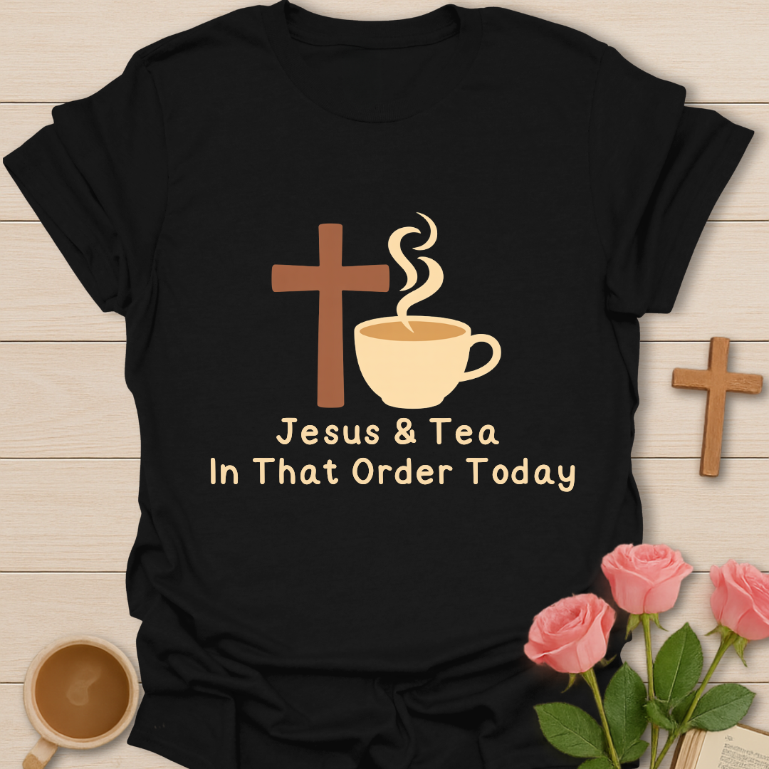 Black t-shirt with 'Jesus & Tea In That Order Today' design on a wooden surface with coffee and roses.