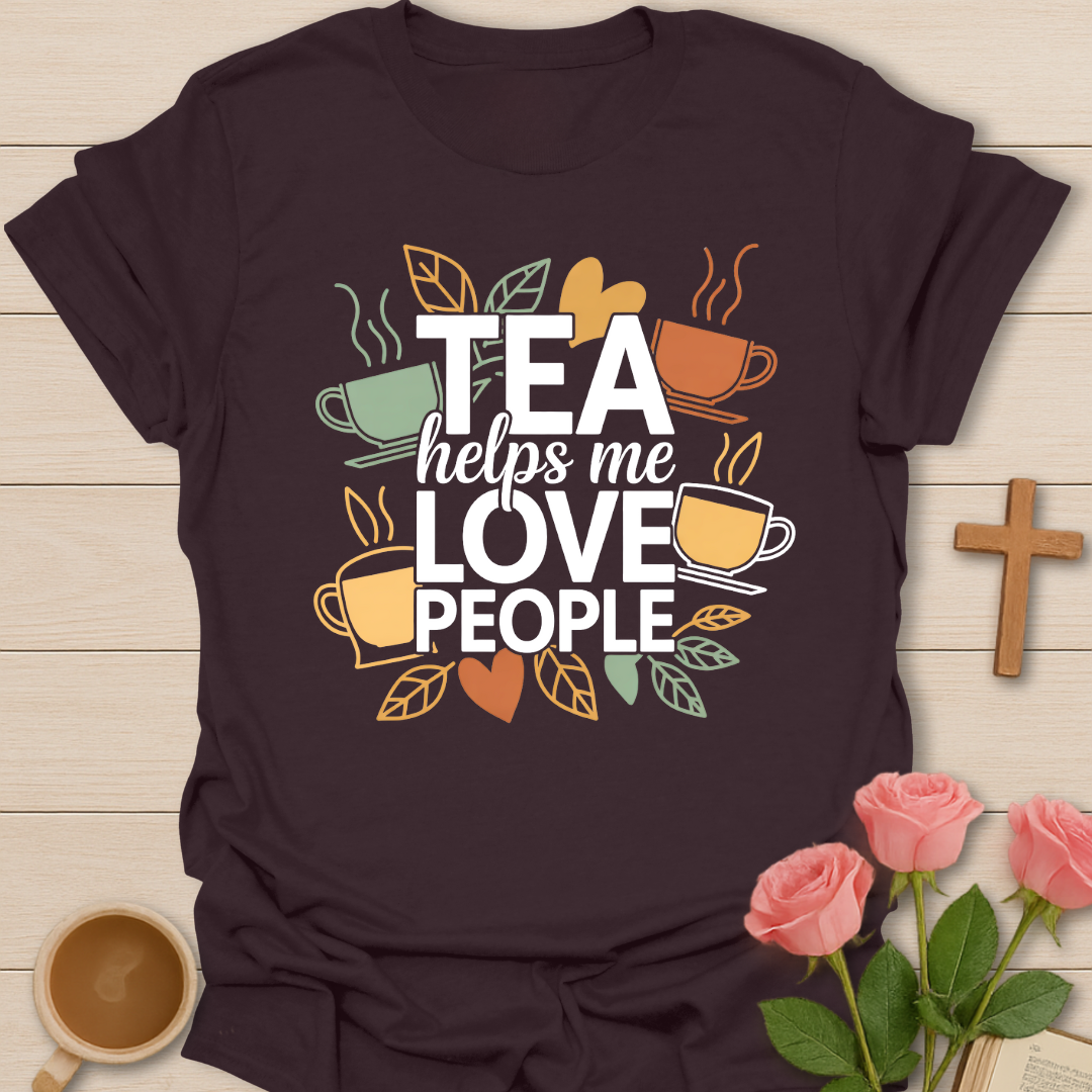 Dark Chocolate t-shirt with illustrated tea cups and leaves surrounding the phrase “Tea Helps Me Love People” in warm earthy tones on a dark background.