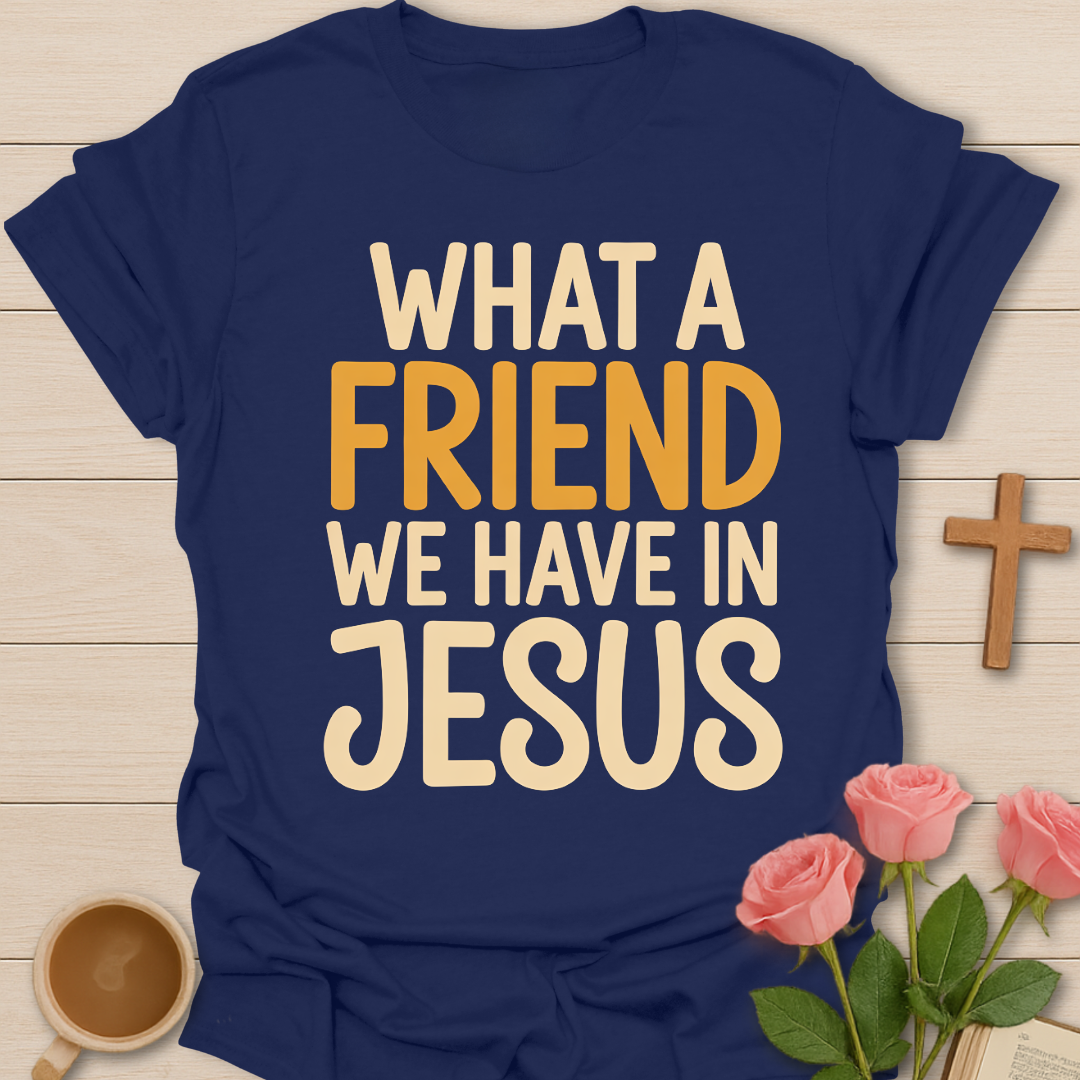 Navy blue t-shirt with 'What a Friend We Have in Jesus' text on a wooden surface with flowers and a cross.