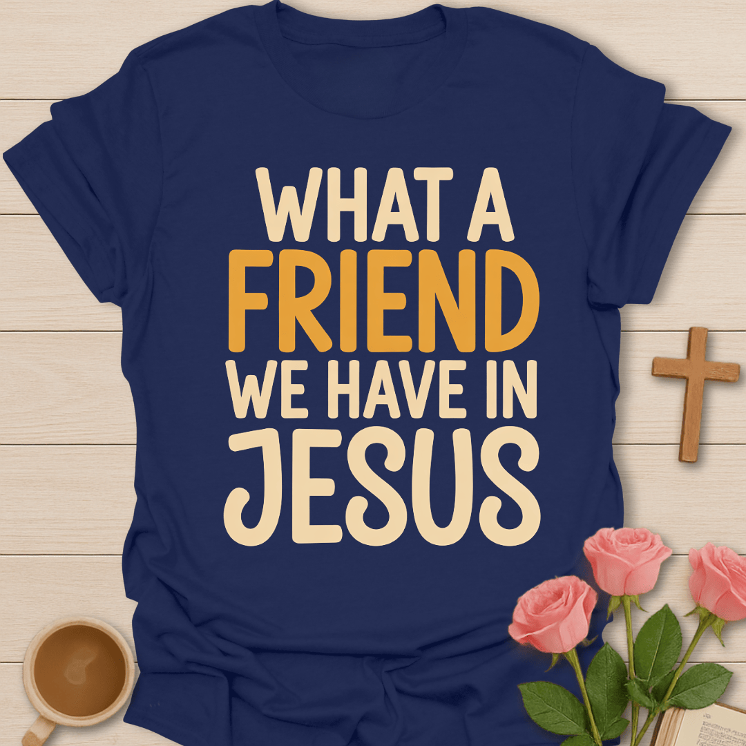 Navy blue t-shirt with 'What a Friend We Have in Jesus' text on a wooden surface with flowers and a cross.