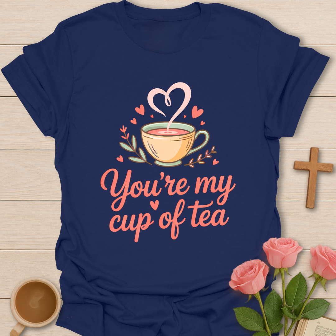 Navy blue t-shirt with 'You're my cup of tea' design on a wooden surface with a coffee cup and roses.