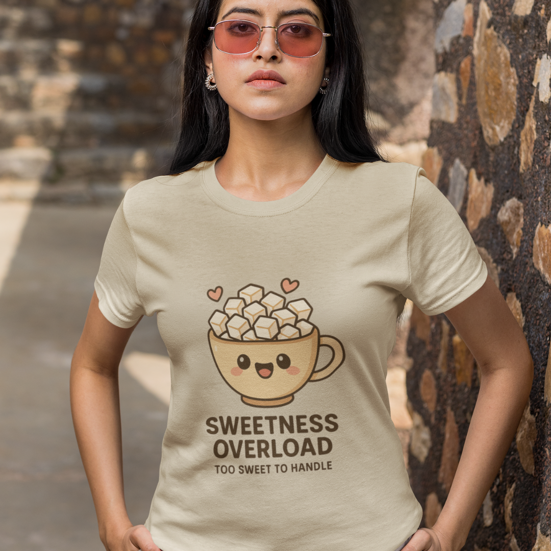 Person wearing a t-shirt with a cup of marshmallows graphic and text.