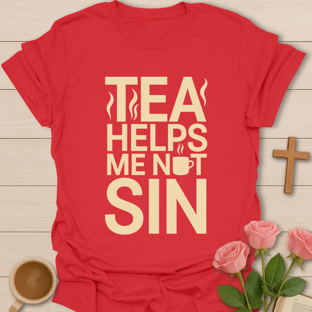 Red t-shirt with 'Tea Helps Me Not Sin' text on a wooden surface with a cup of tea and roses.