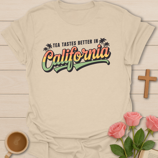 Beige Women’s tea lover t-shirt with retro sunset lettering reading “Tea Tastes Better in California,” cozy California aesthetic graphic tee