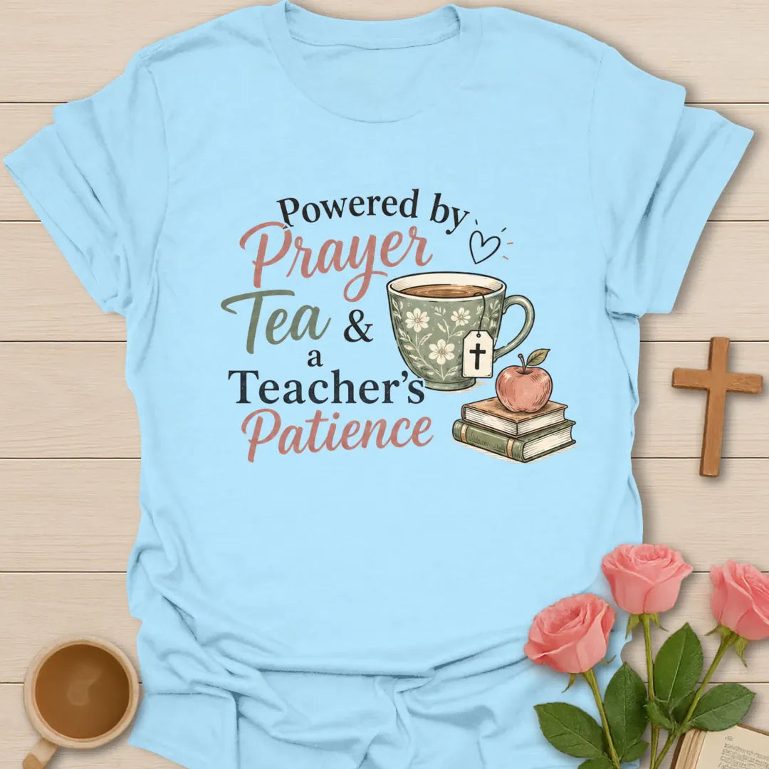 A Teacher's Patience shirt with apple, teacup, cross, and cream vintage lettering. - Light Blue