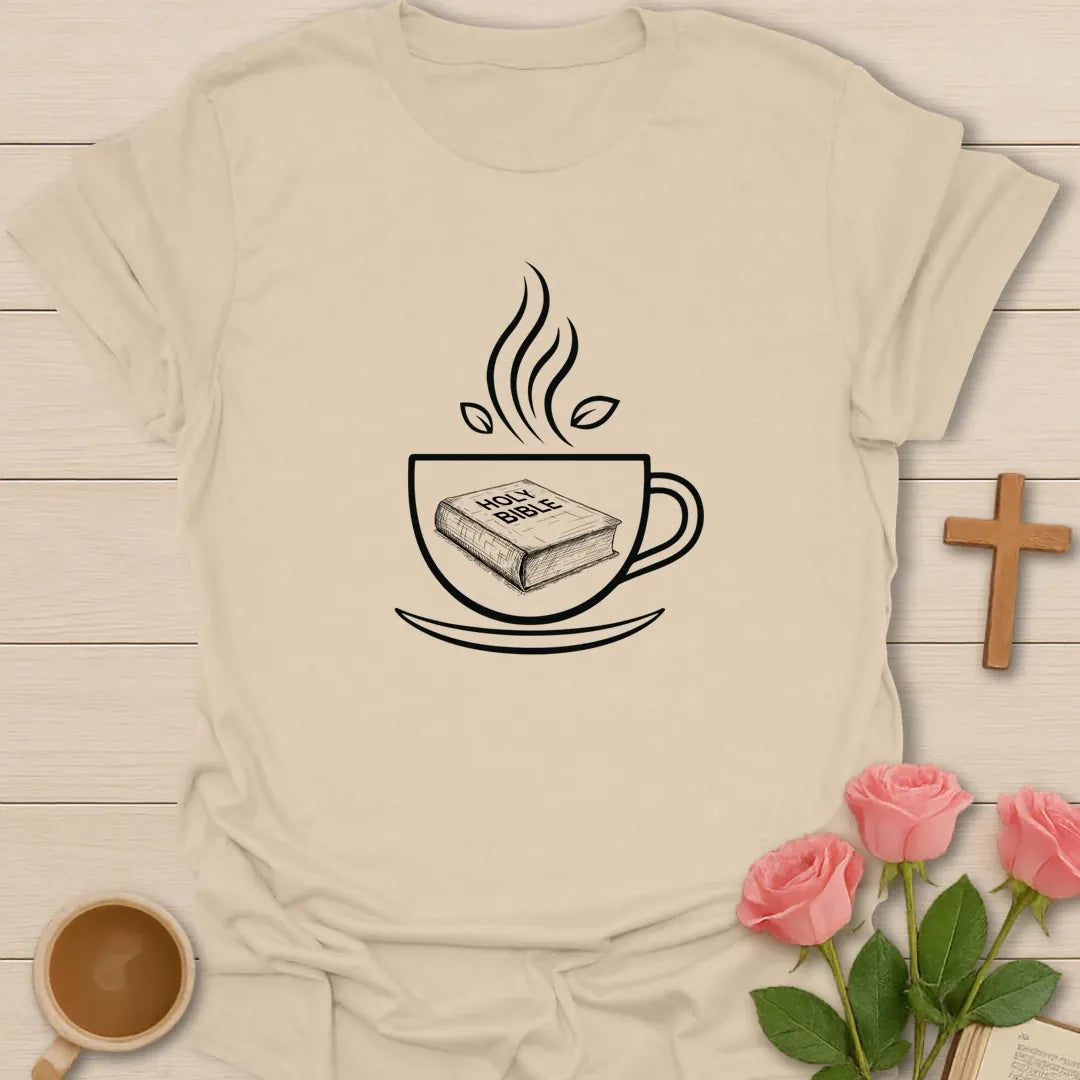 Minimalist Christian t-shirt with line art of a Holy Bible resting inside a steaming teacup with tea leaves - Sand