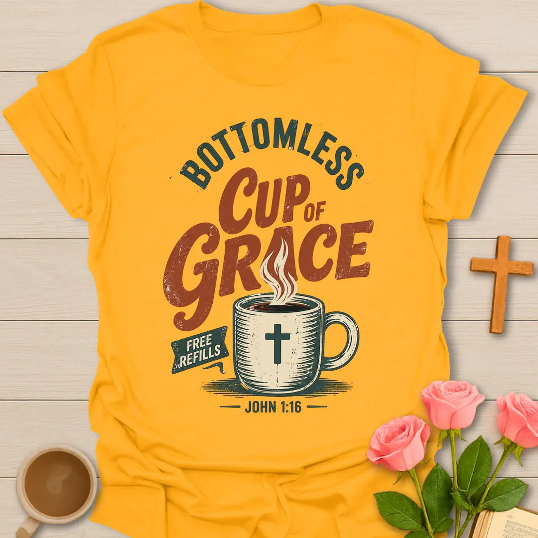 Bottomless Cup of Grace vintage Christian t-shirt with a steaming mug marked with a cross, a Free Refills banner and John 1:16 - Gold