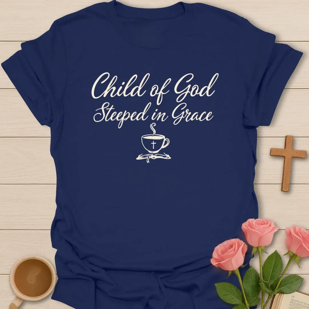 Child of God Steeped in Grace shirt with cream script lettering, teacup with cross, and minimalist faith design. - Navy