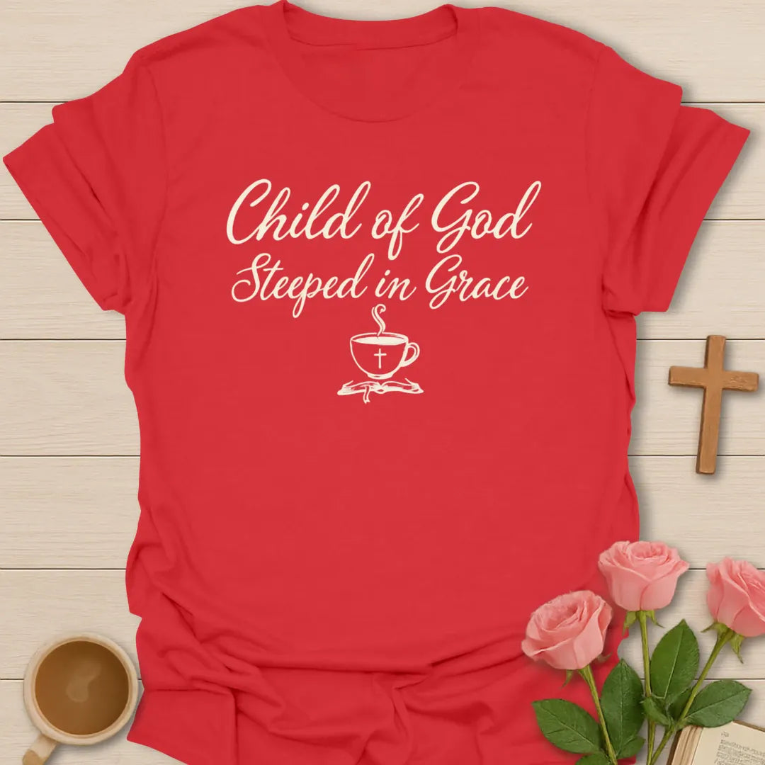 Child of God Steeped in Grace shirt with cream script lettering, teacup with cross, and minimalist faith design. - Red
