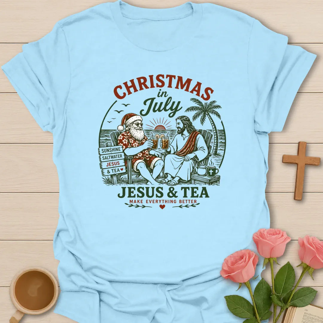 Christmas in July Christian shirt with tropical beach scene, palm trees, cross, and festive summer holiday design. - Light Blue