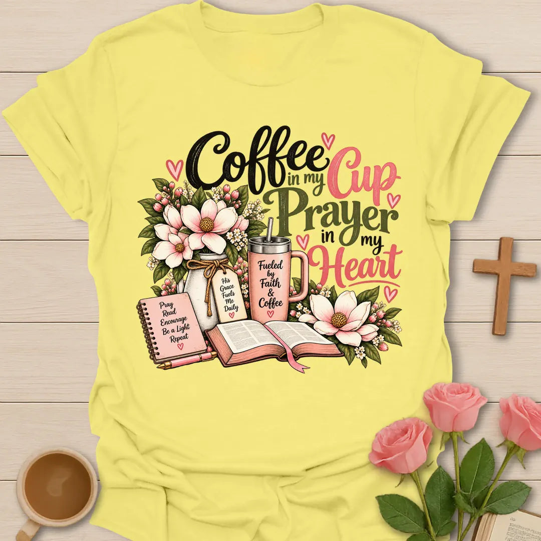 Coffee In My Cup, Prayer In My Heart Christian t-shirt with pink flowers, an open Bible, a prayer journal, and a coffee tumbler - Cornsilk