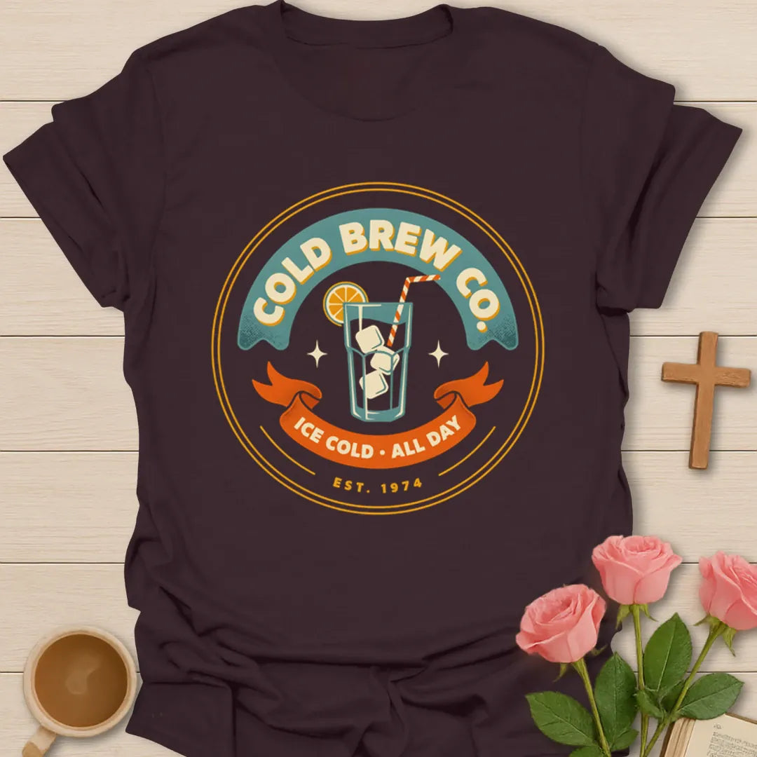 Cold Brew Co iced tea shirt with vintage badge, iced drink, orange slice, straw, stars, and Ice Cold All Day text - Dark Chocolate