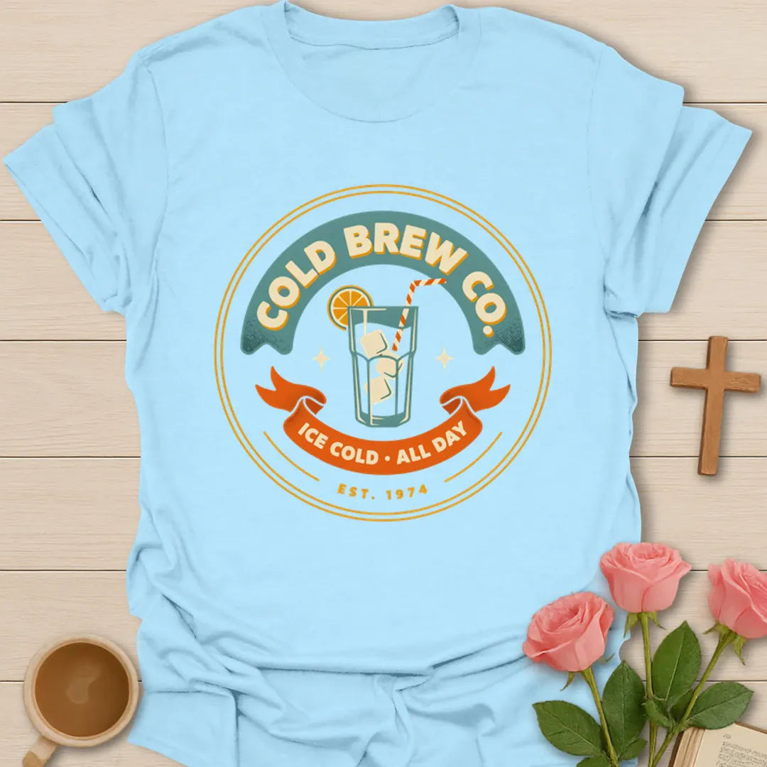 Cold Brew Co iced tea shirt with vintage badge, iced drink, orange slice, straw, stars, and Ice Cold All Day text - Light Blue