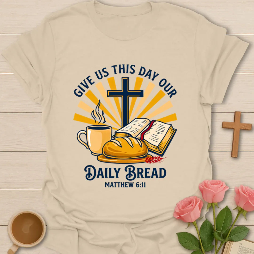 Daily Bread Christian shirt with open Bible, bread, cross, sun rays, and coffee cup. - Sand