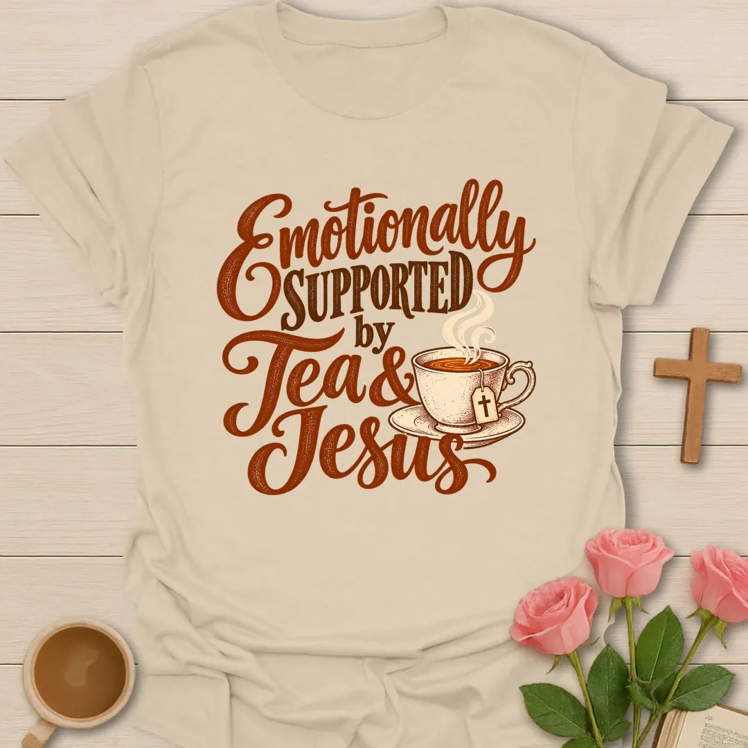 Emotionally Supported by Tea & Jesus Christian t-shirt with rust script lettering and a teacup with a cross tea tag - Sand