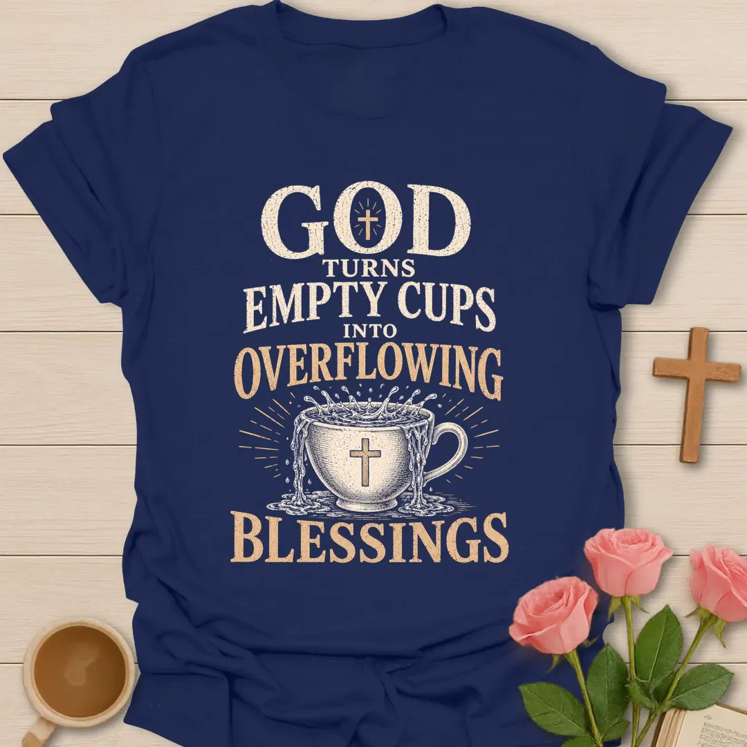 God Turns Empty Cups Into Overflowing Blessings t-shirt with vintage lettering and an overflowing teacup marked with a cross. - Navy