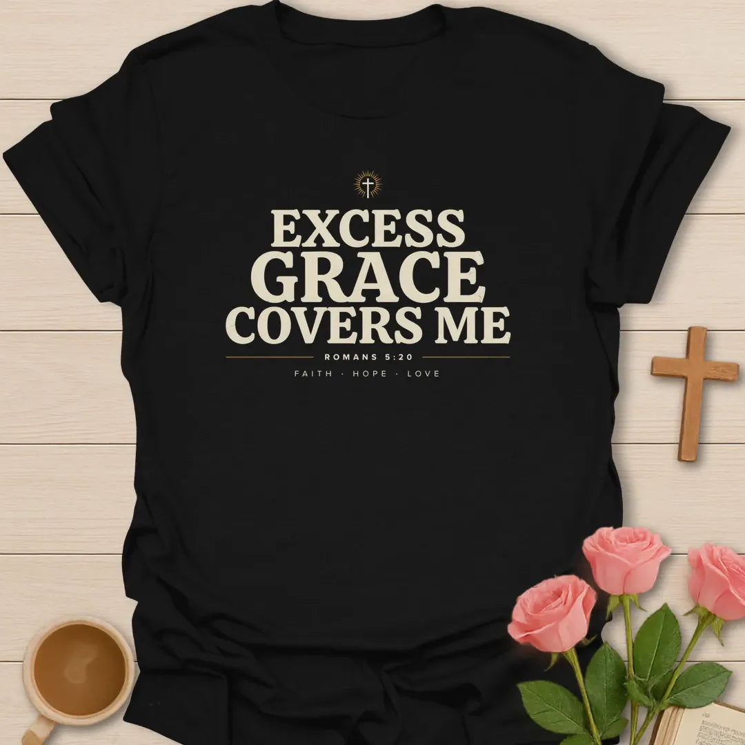 Excess Grace Covers Me shirt with bold cream lettering, small cross, Romans 5:20 text, and faith hope love accents. - Black