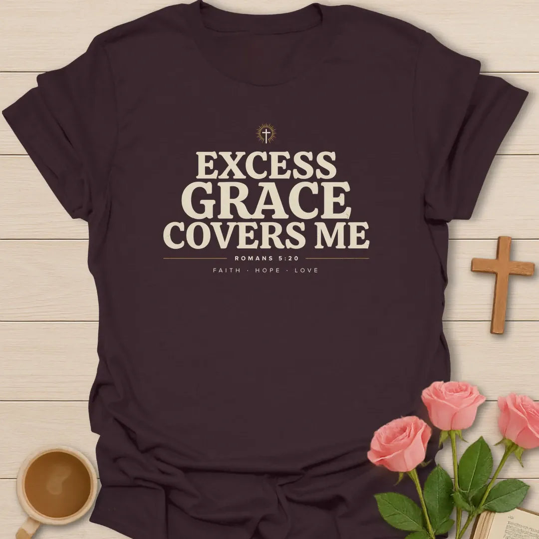 Excess Grace Covers Me shirt with bold cream lettering, small cross, Romans 5:20 text, and faith hope love accents. - Dark Chocolate