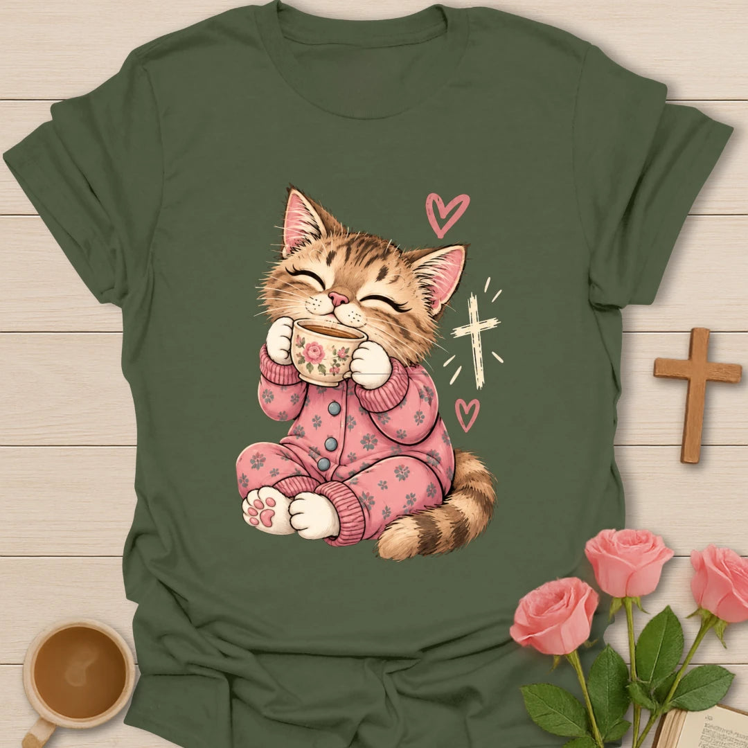 Feline Loves Tea Christian t-shirt with a smiling kitten in pink pajamas holding a teacup beside a cross - Military Green
