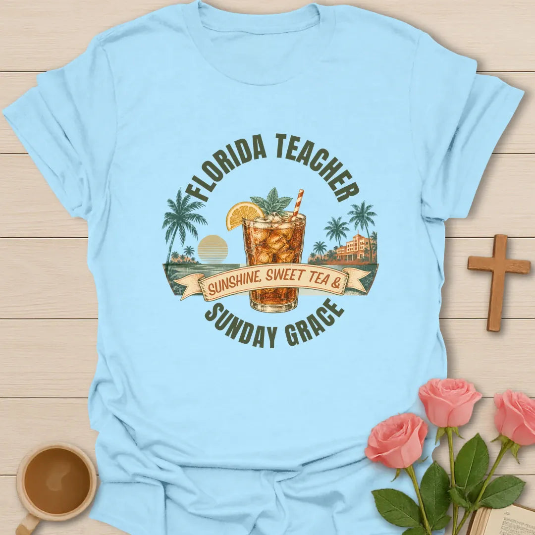 Florida Teacher shirt with arched green text, iced sweet tea glass, orange slice, palms, sunset, ribbon banner, and Sunday Grace wording. - Light Blue