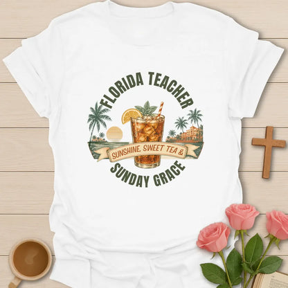 Florida Teacher shirt with arched green text, iced sweet tea glass, orange slice, palms, sunset, ribbon banner, and Sunday Grace wording. - White
