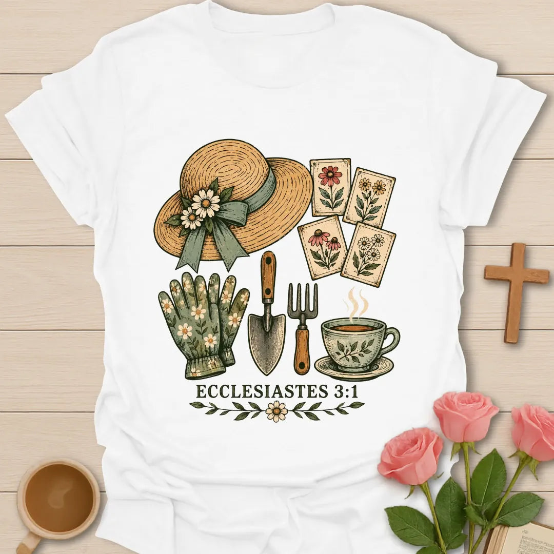 Gardening Faith Christian t-shirt with a straw sun hat, flower seed packets, gloves, trowel, garden fork, teacup and Ecclesiastes 3:1 - White