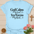 God Calms Tea Warms Christian tea t-shirt with calming lettering and faith-inspired design. - Light Blue