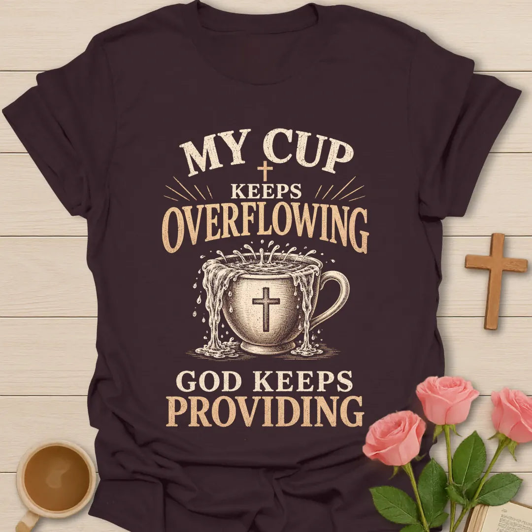 My Cup Keeps Overflowing, God Keeps Providing t-shirt with vintage lettering and an overflowing teacup marked with a cross. - Dark Chocolate