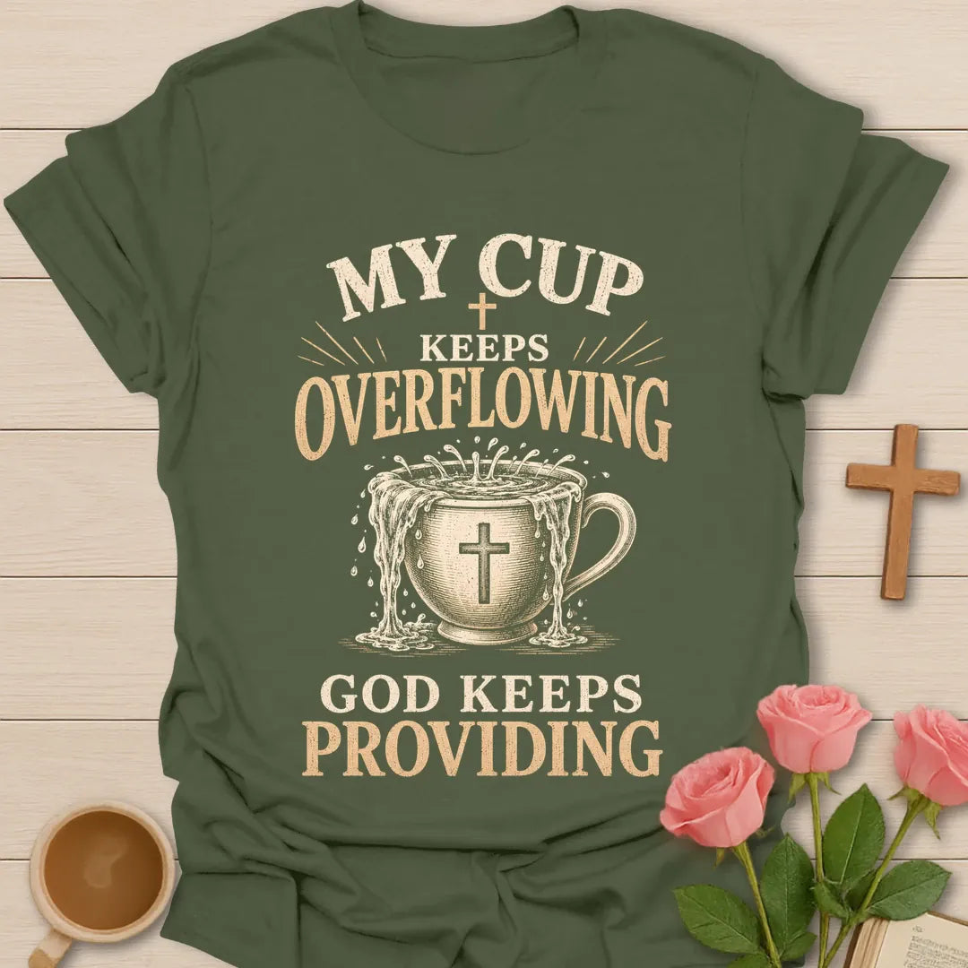 My Cup Keeps Overflowing, God Keeps Providing t-shirt with vintage lettering and an overflowing teacup marked with a cross. - Military Green
