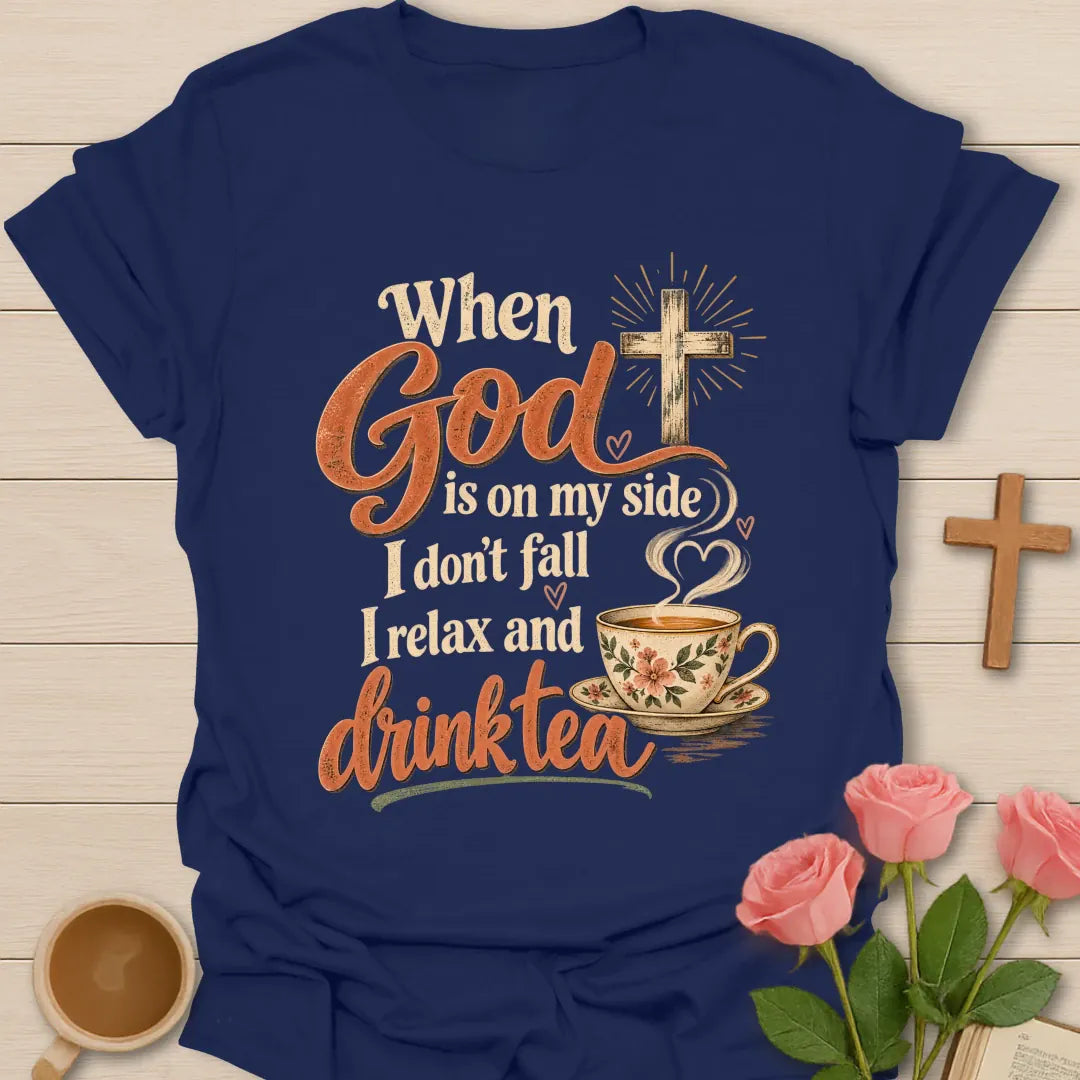 When God Is On My Side I Don't Fall, I Relax And Drink Tea t-shirt with a glowing cross and floral teacup in script lettering - Navy