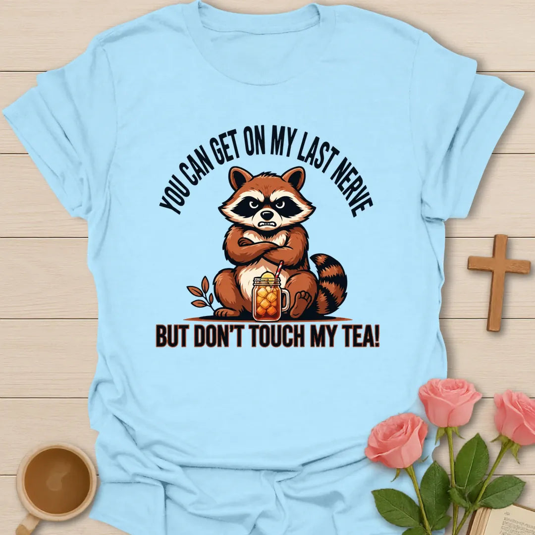 Grumpy Raccoon Tea t-shirt with a grumpy raccoon and tea-themed faith design - Light Blue