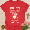 Bring Him Your Empty Cup, He Knows How To Fill It t-shirt with vintage lettering and a teacup marked with a cross. - Red