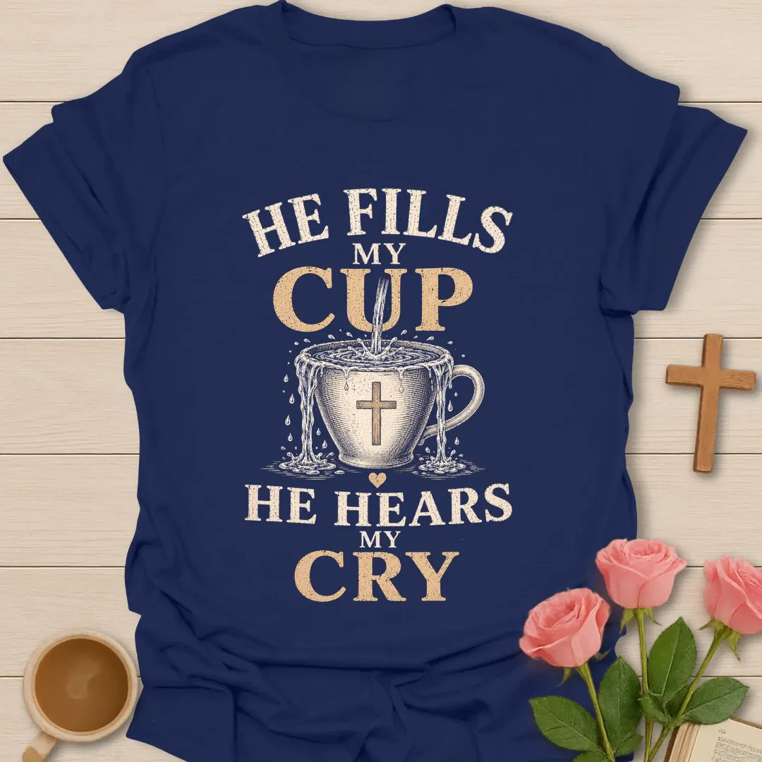 He Fills My Cup, He Hears My Cry t-shirt with vintage lettering and tea pouring into an overflowing cross-marked teacup. - Navy