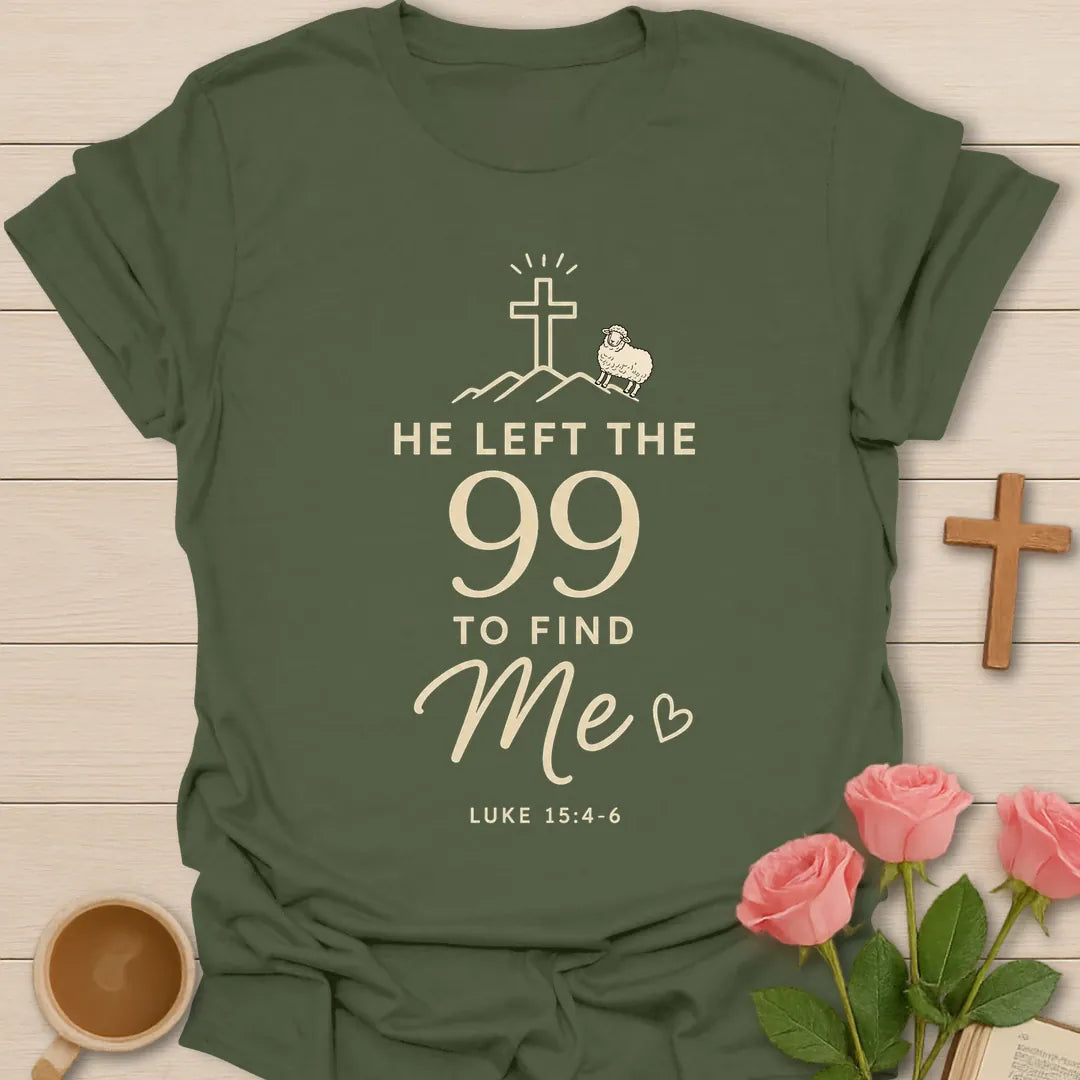 He Left The 99 To Find Me shirt with cross, mountain line art, small sheep, heart, and Luke 15:4-6 text. - Military Green