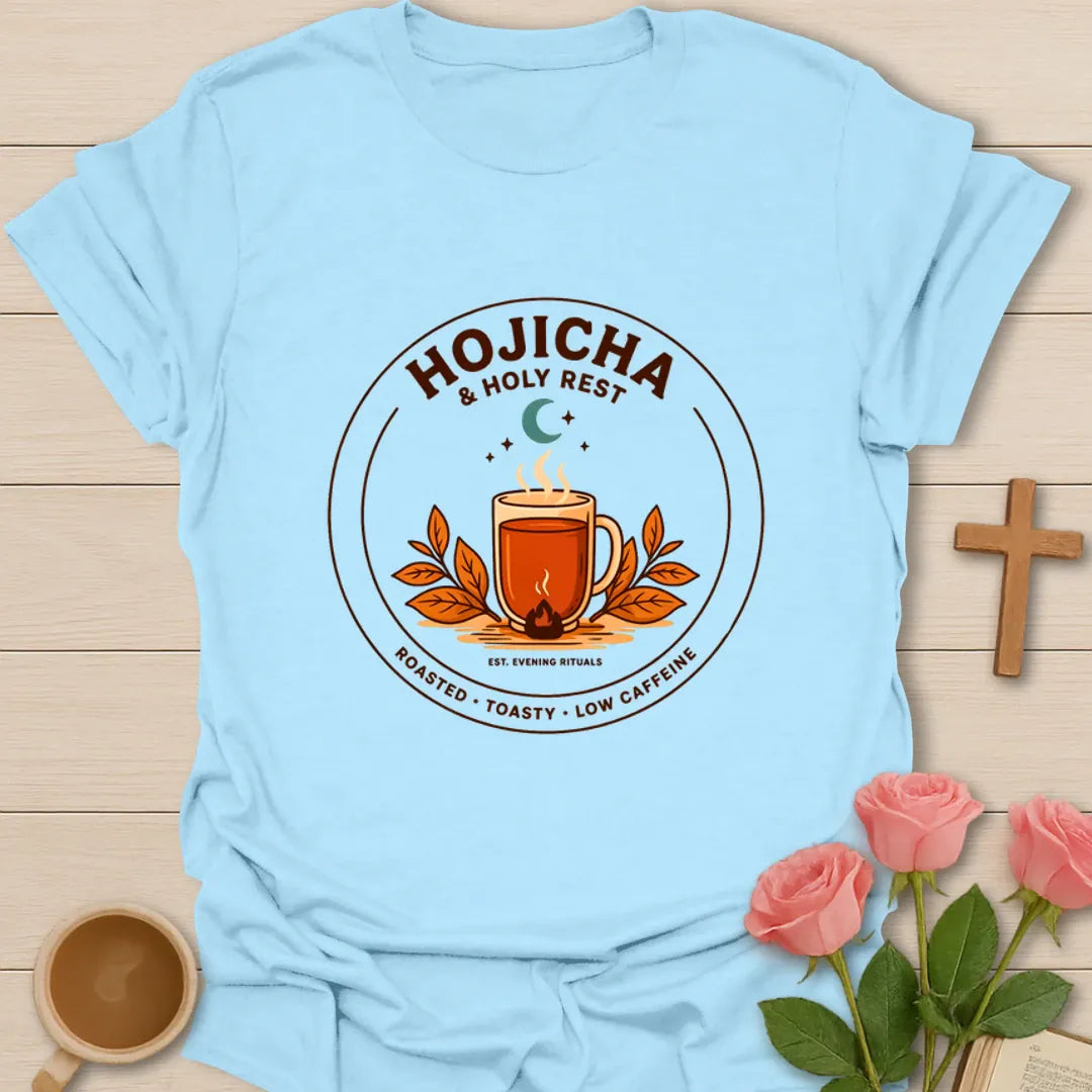 Hojicha and Holy Rest shirt with steaming amber tea, moon, leaves, evening ritual badge, and low caffeine text. - Light Blue