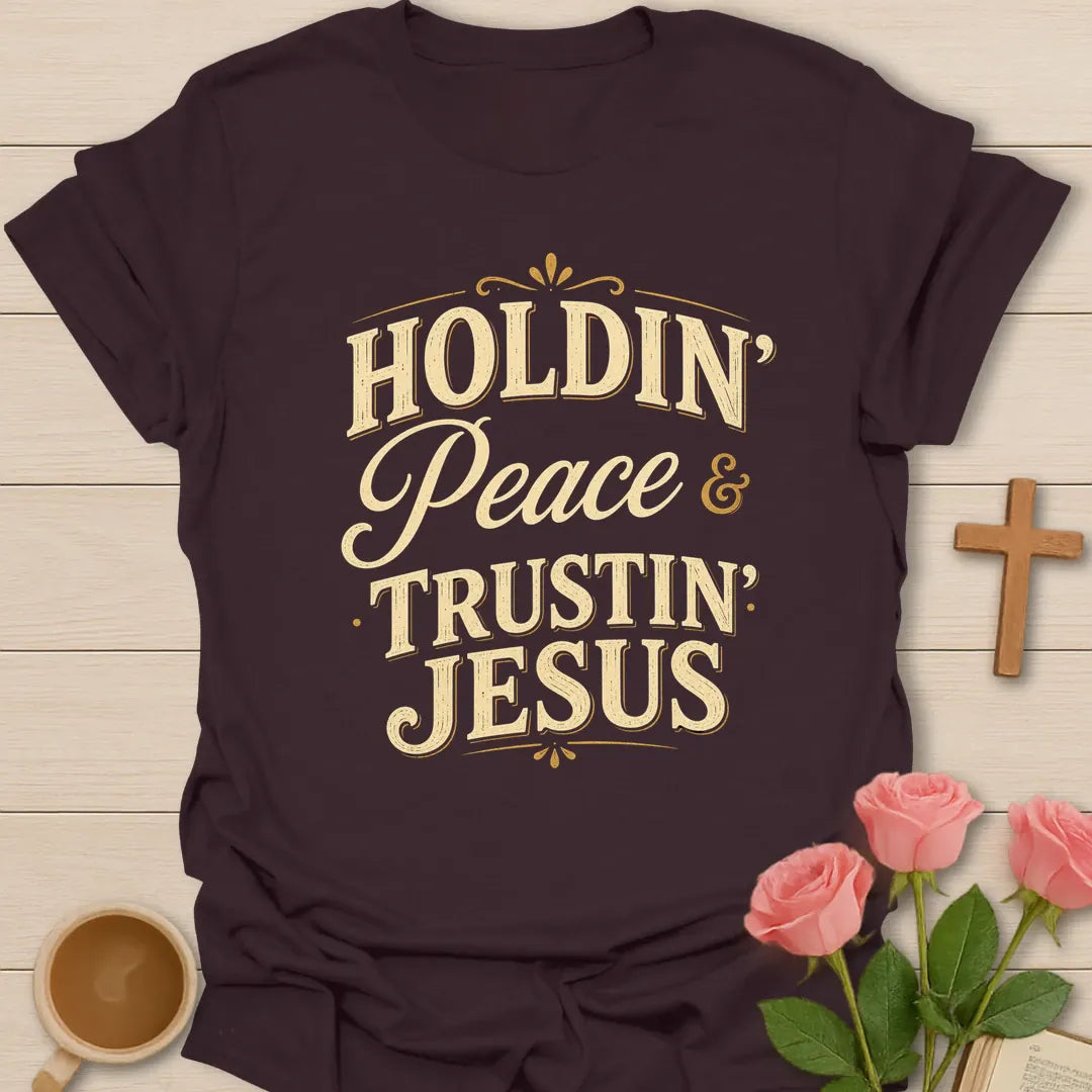 Holdin Peace and Trustin Jesus shirt with cream vintage lettering, script peace text, and bold stacked typography. - Dark Chocolate