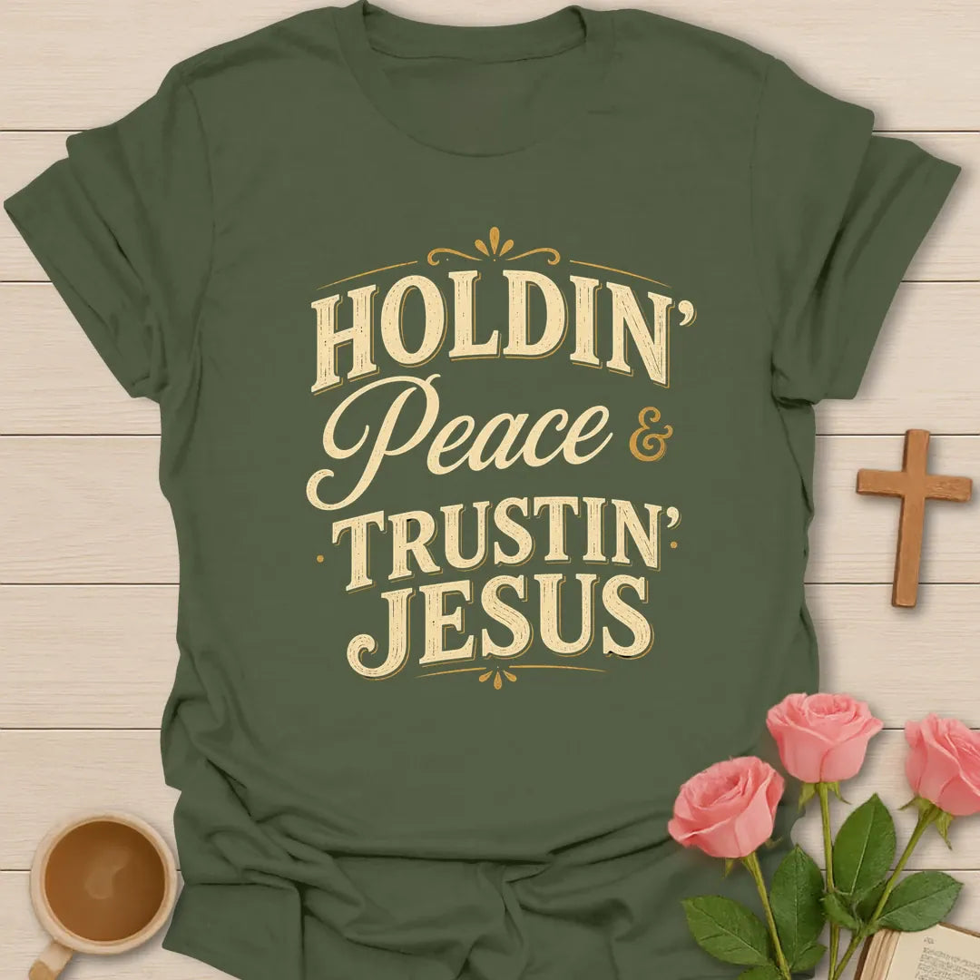 Holdin Peace and Trustin Jesus shirt with cream vintage lettering, script peace text, and bold stacked typography. - Military Green