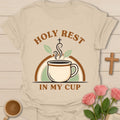 Holy Rest In My Cup Christian shirt with steaming teacup, cross, leaves, and retro rainbow design. - Sand