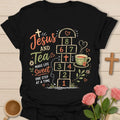 Jesus and Tea hopscotch shirt with numbered hopscotch path, teacup, cross, flowers, hearts, and Make Life Sweet text. - Black