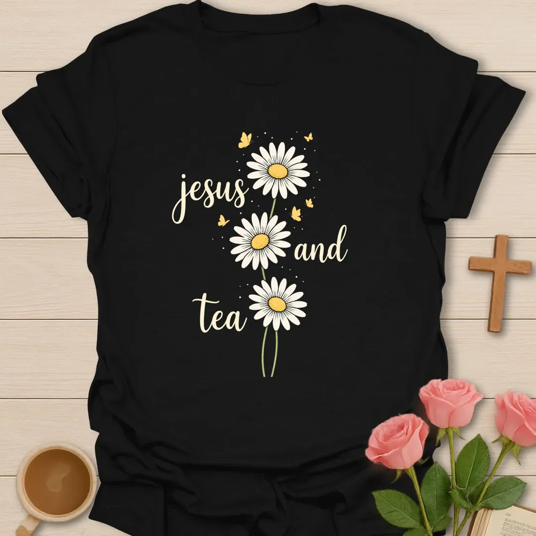 Jesus and Tea daisy shirt with three white daisies, yellow butterflies, cream script lettering, and airy botanical accents. - Black