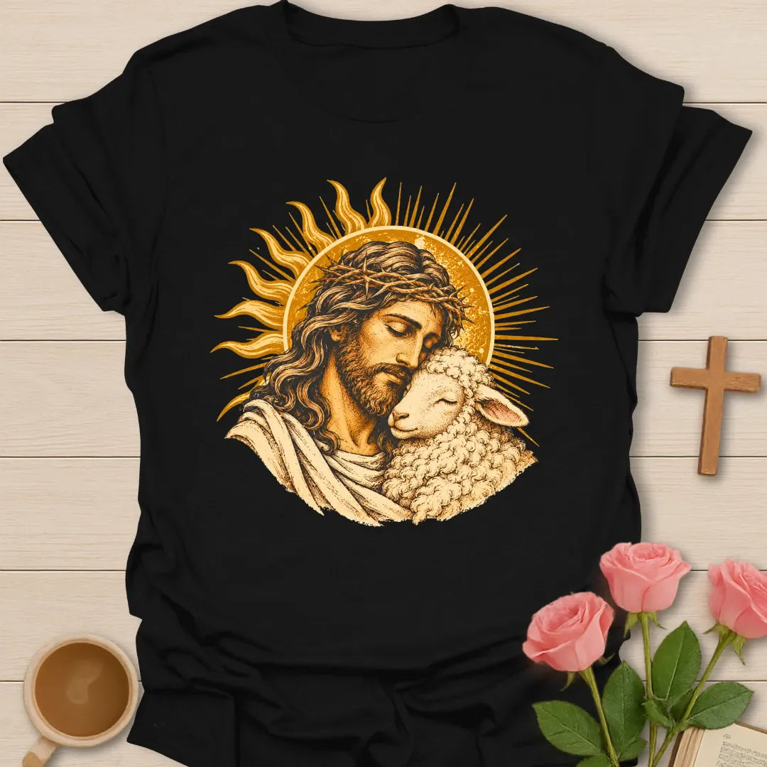 Jesus Embrace t-shirt with a vintage golden illustration of Jesus wearing a crown of thorns holding a lamb close against a radiant sun - Black