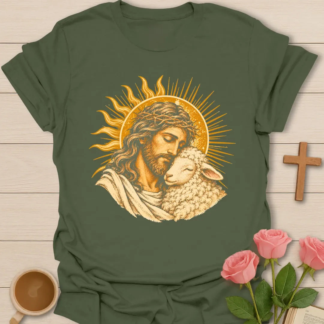 Jesus Embrace t-shirt with a vintage golden illustration of Jesus wearing a crown of thorns holding a lamb close against a radiant sun - Military Green