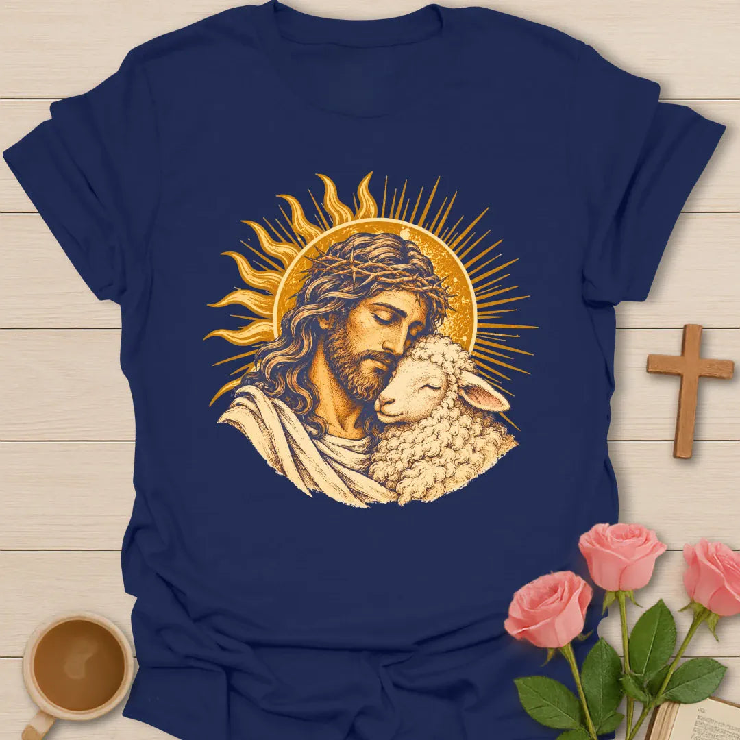 Jesus Embrace t-shirt with a vintage golden illustration of Jesus wearing a crown of thorns holding a lamb close against a radiant sun - Navy