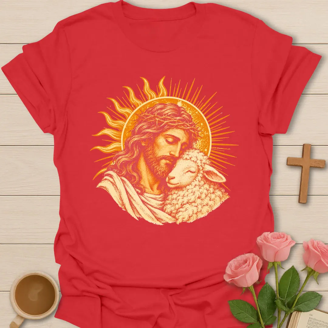 Jesus Embrace t-shirt with a vintage golden illustration of Jesus wearing a crown of thorns holding a lamb close against a radiant sun - Red
